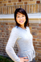 Woman in gray business jacket in front of brown brick wall at the Presidio Library in San Francisco