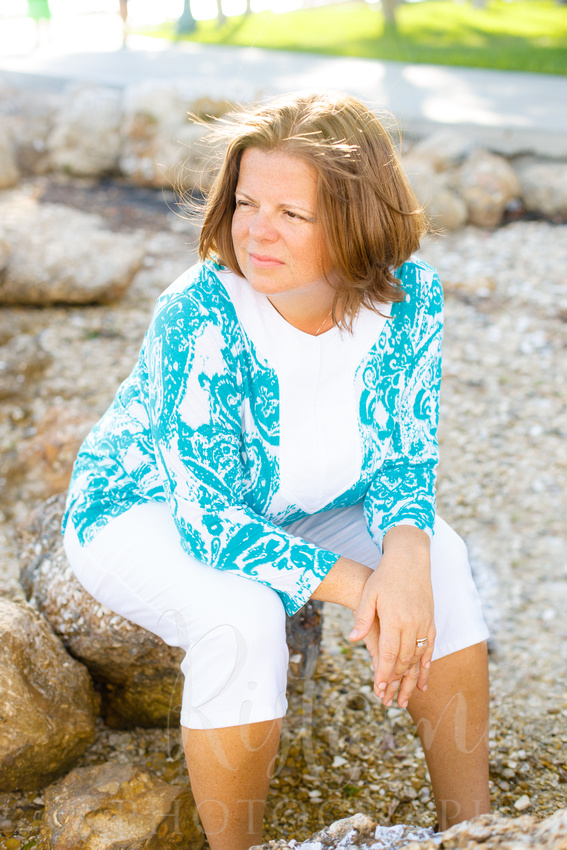 Authentic Sarasota headshots of a woman in caribbean blue at Island Park in Sarasota FL