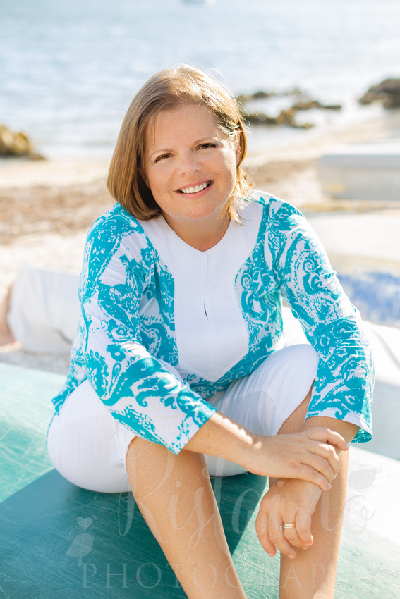 Authentic Sarasota headshots of a woman in caribbean blue at Island Park in Sarasota FL