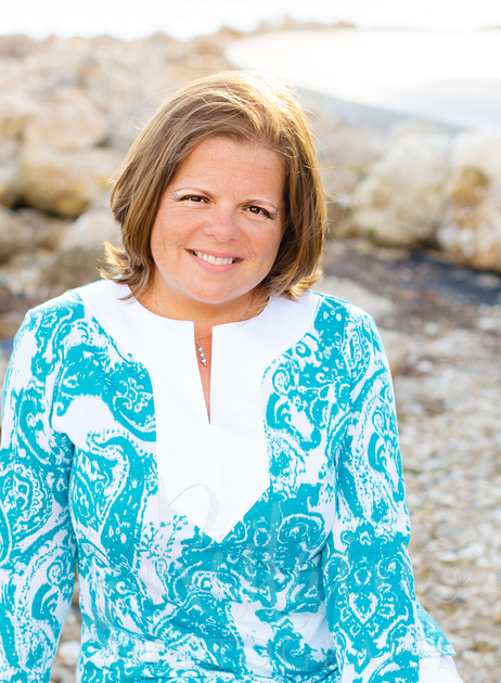 Authentic Sarasota headshots of a woman in caribbean blue at Island Park in Sarasota FL