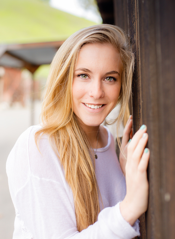 Joyful portrait of a young lady next to a barn in Walnut Creek