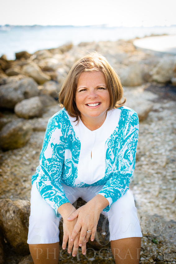 Authentic Sarasota headshots of a woman in caribbean blue at Island Park in Sarasota FL